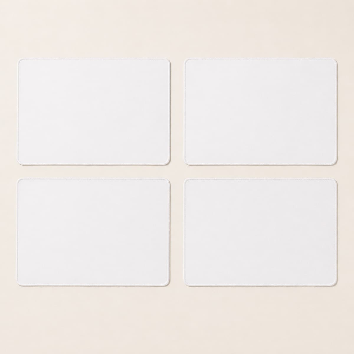 Placemat, Set of 4, an unprinted 100% polyester face, felt backing blank photographed flat on almond paper.